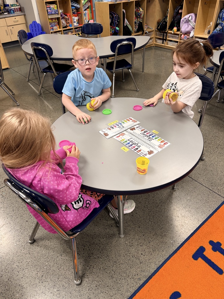 Kindergarten having fun creating snakes!
