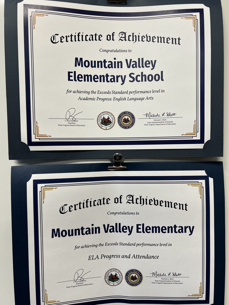 Two framed certificates are displayed. Each has a blue border with gold text. One certificate says "Mountain Valley Elementary School" and the other says "Mountain Valley Elementary".