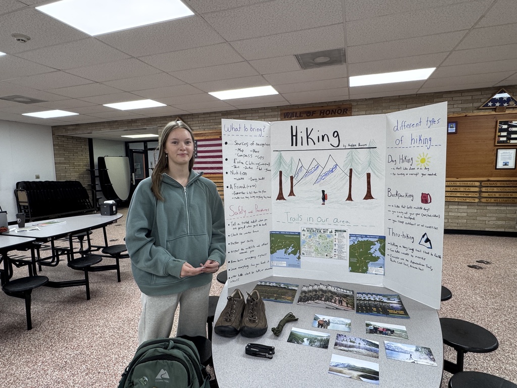 Student beside tri-fold display