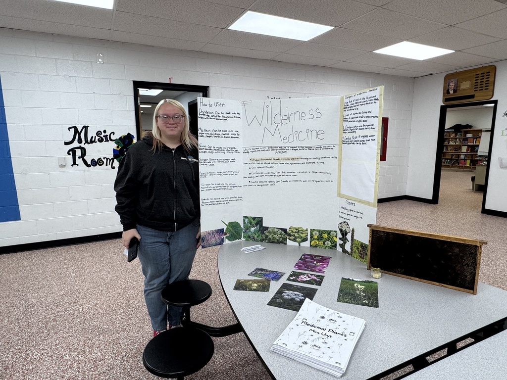 Student beside tri-fold display