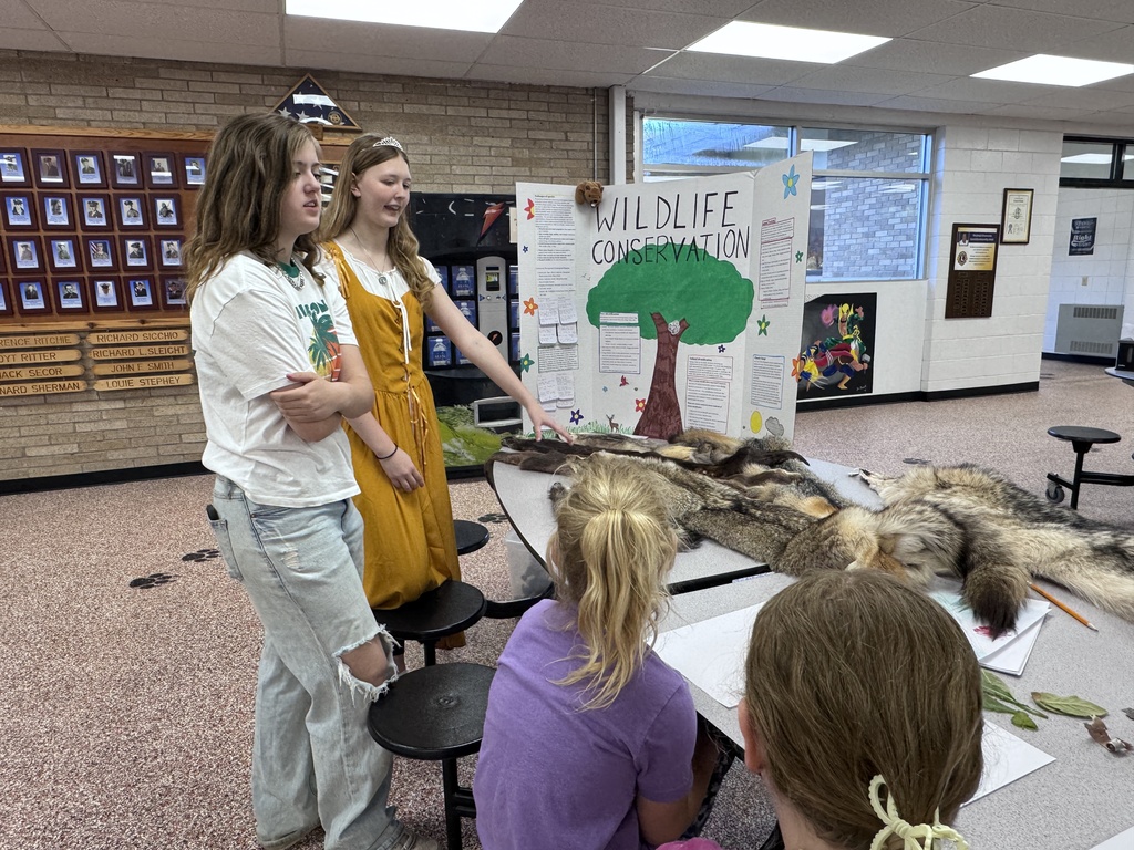 Student beside tri-fold display