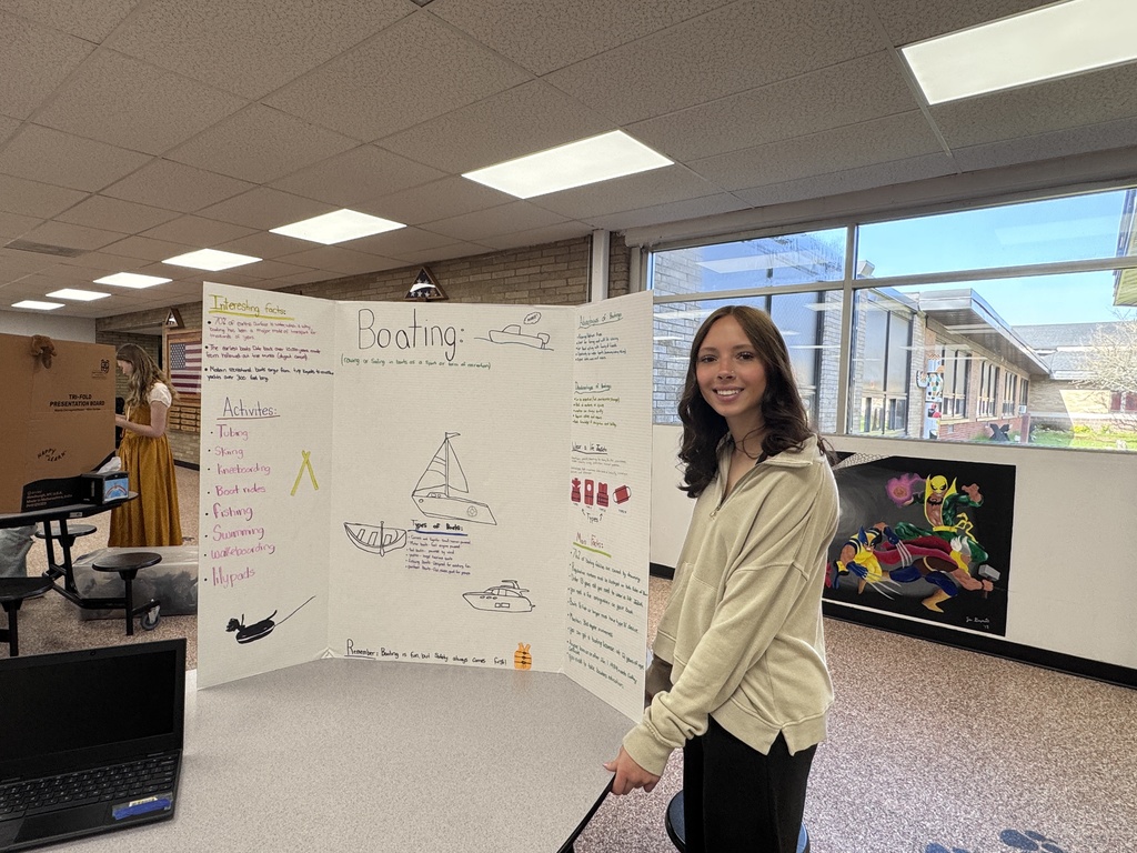 Student beside tri-fold display