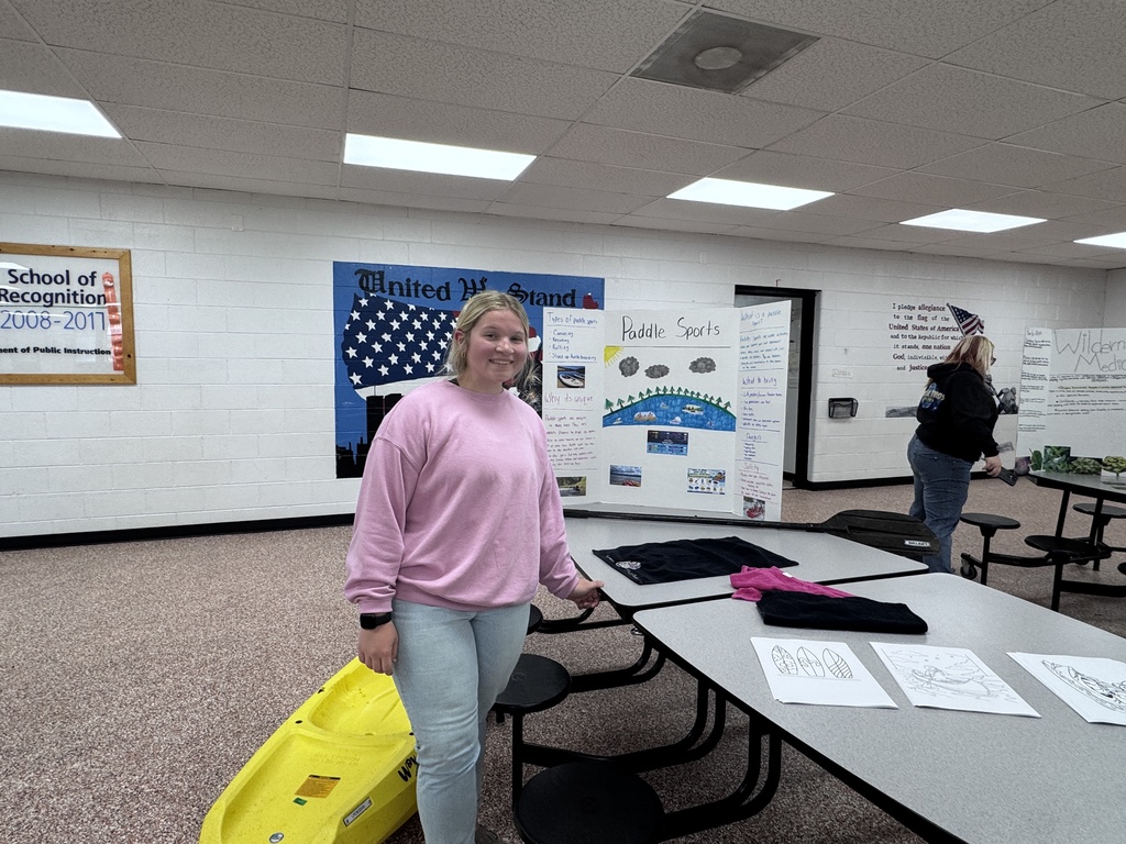 Student beside tri-fold display
