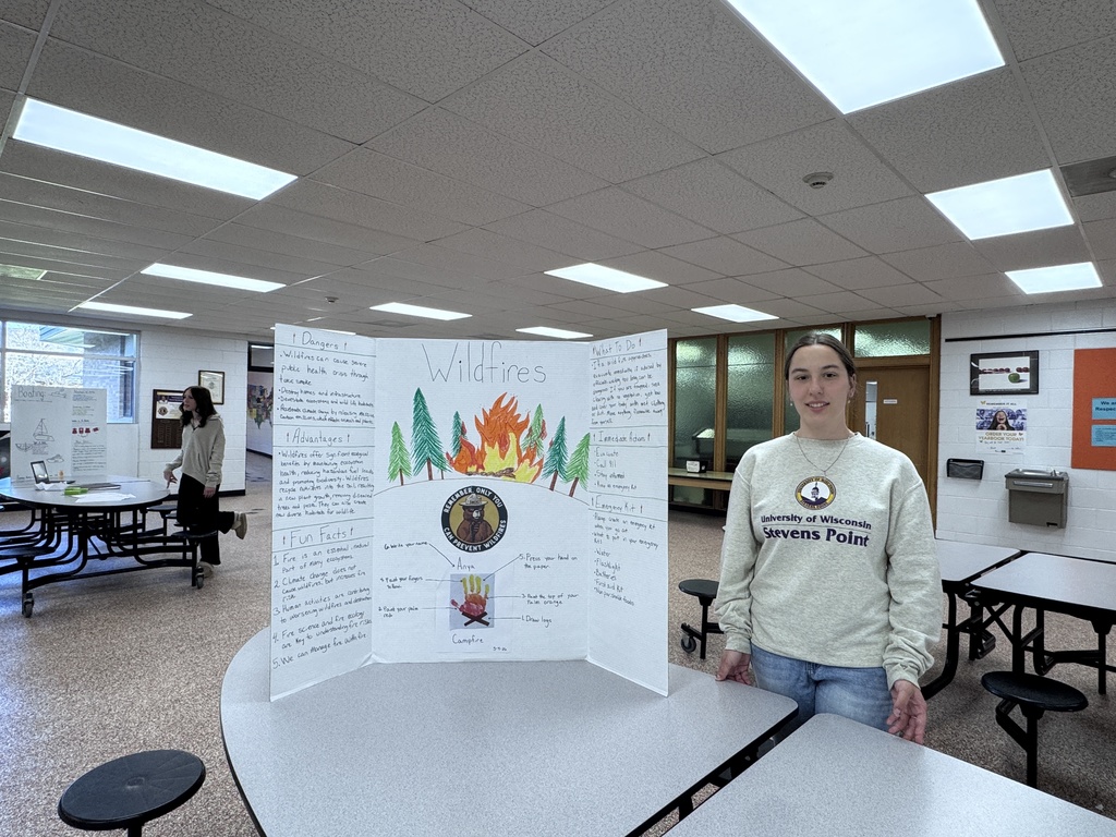 Student beside tri-fold display