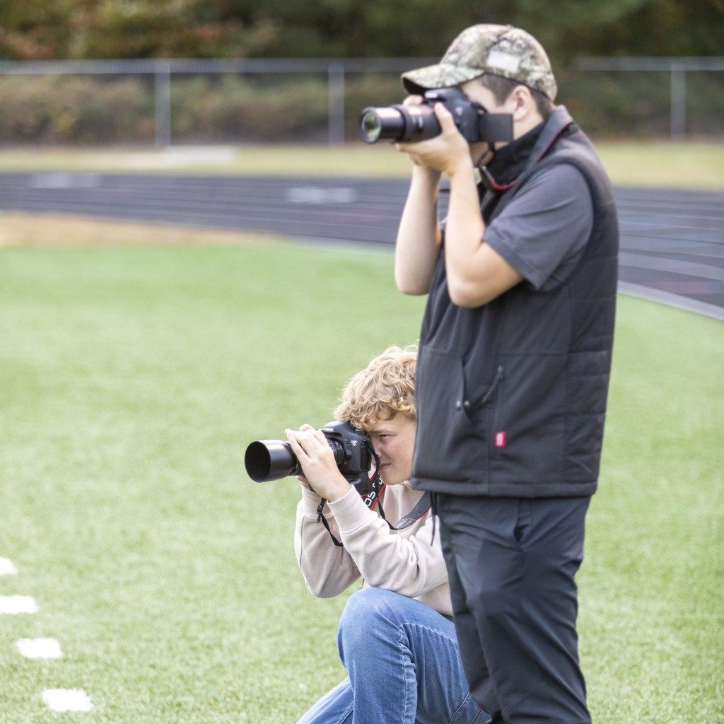 Student photographers at football game.