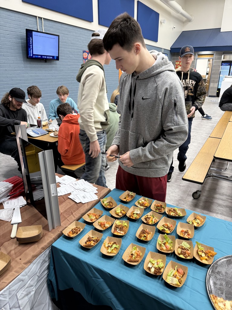 A student standing in line at the student choice line to pick his favorite pizza option that he tried today during lunch at MECHS. 