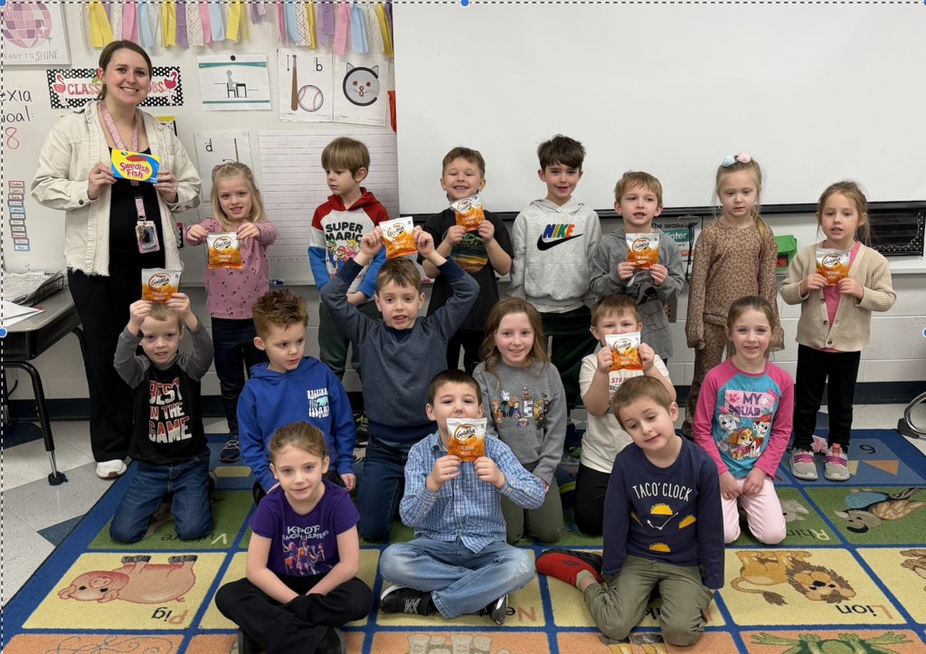 Mrs. Wardin's Kindergarten class celebrates winning the naming of a reef going into Sanford Lake.