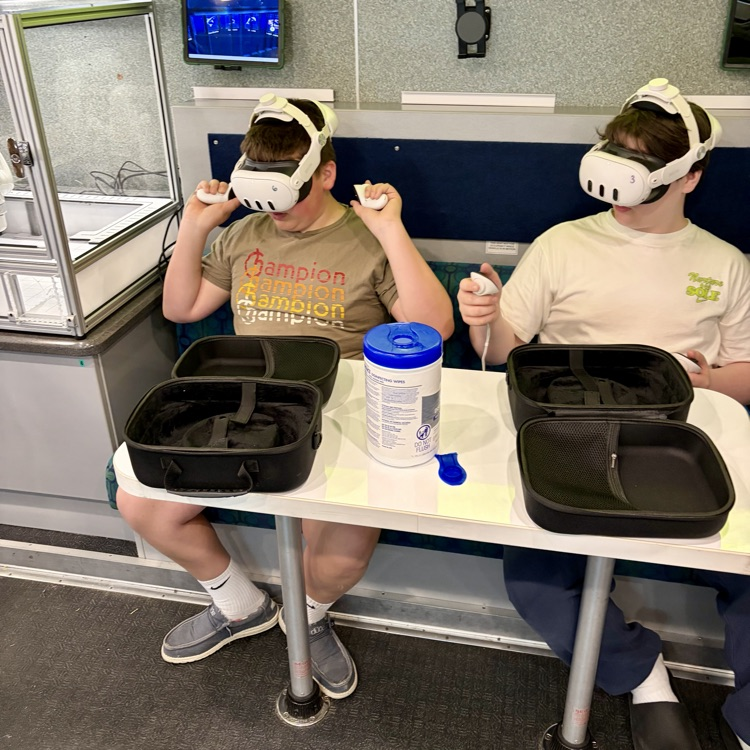 students using a VR headset to view an underwater ocean simulation