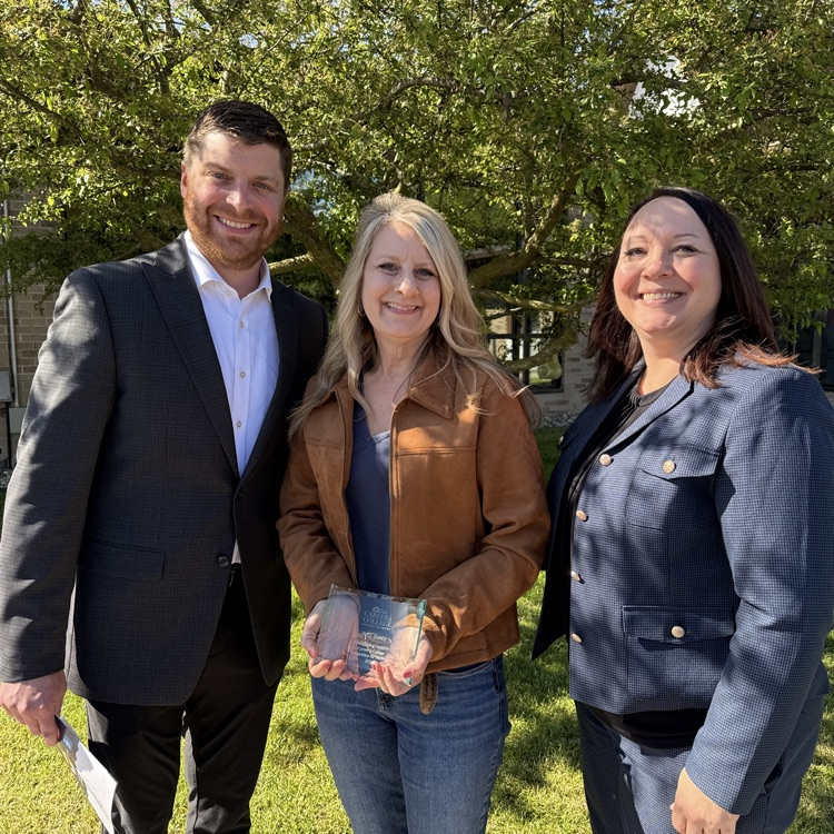 Amy Boxey, Scott LaFever, and Sarah Glann at an awards ceremony posing for a photo with an award  