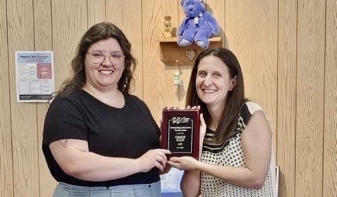 Miss Ellis being given her award
