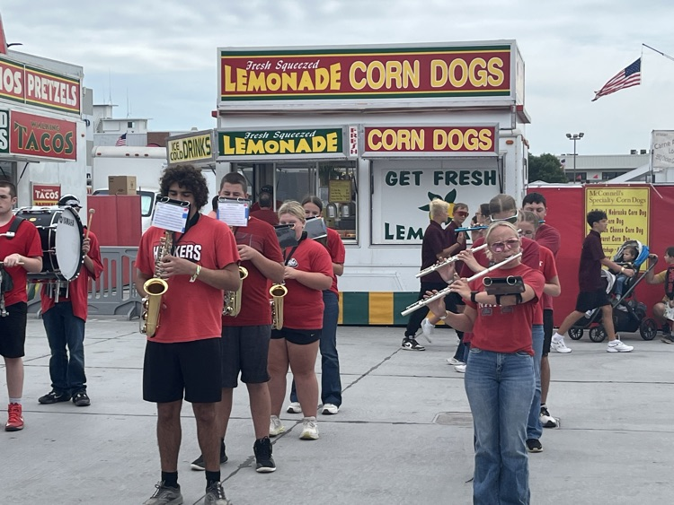 Band members marching and playing at the stat