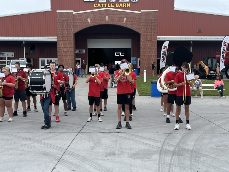 Band members marching and playing at the stat