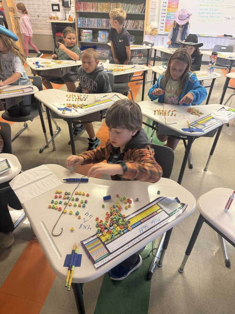 3rd graders are learning about the distributive property of multiplication by making fruit loop arrays!