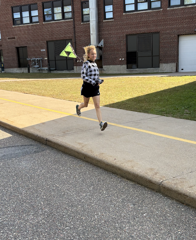 Kid in black flying kite for STEAM Class