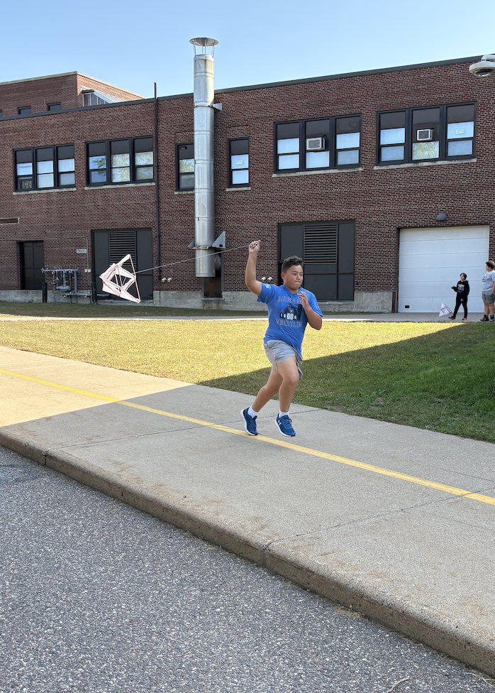 Kid in blue flying kite