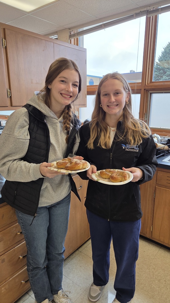 Two students holding homemade pretzels