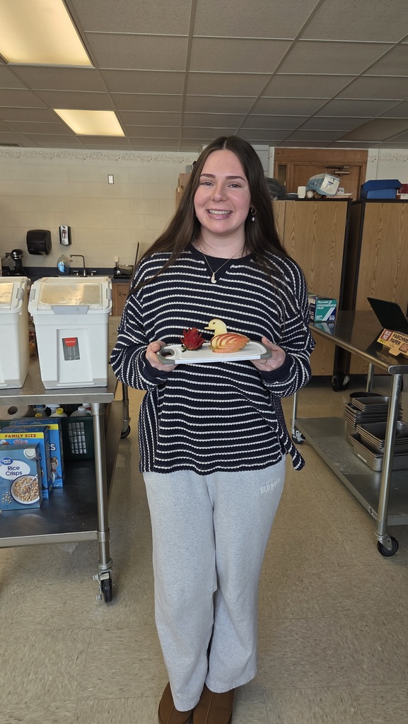 Student holding a flower made out of food