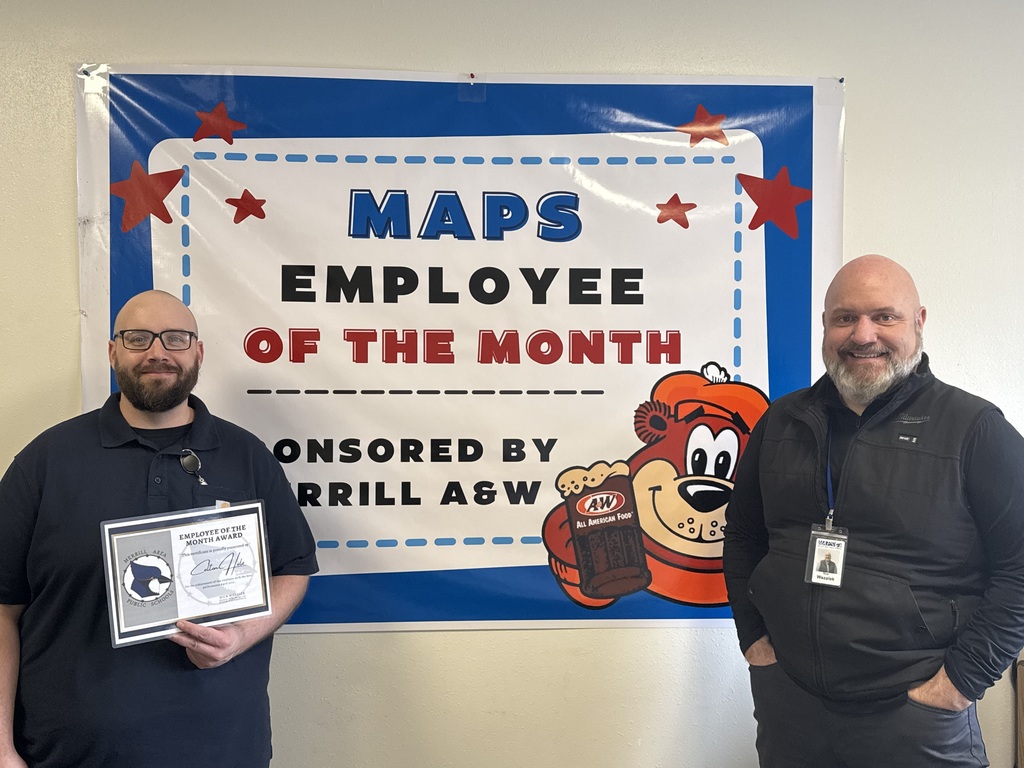 Two  males standing in front of a sign that says, "MAPS Employee of the Month" sponsored by Merrill A &W