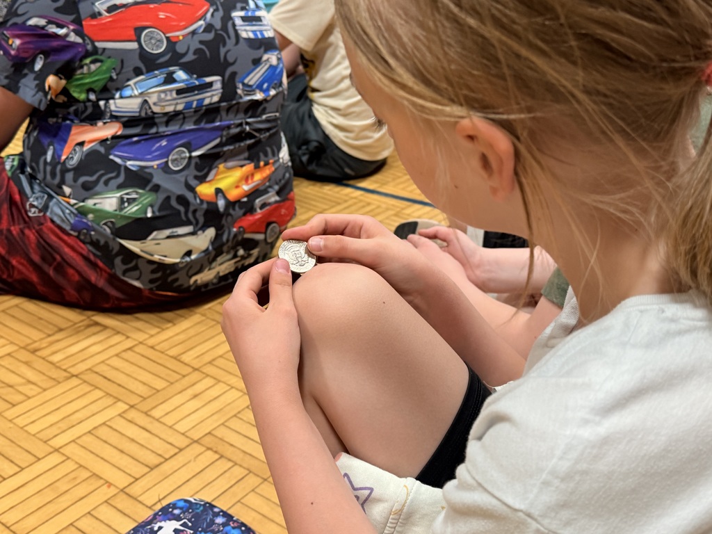 A student looking at a coin