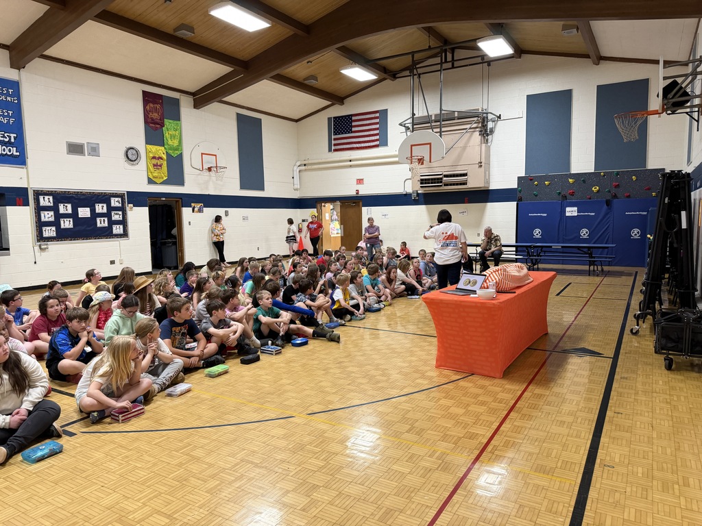 Susan Ryman presenting to students seated on floor