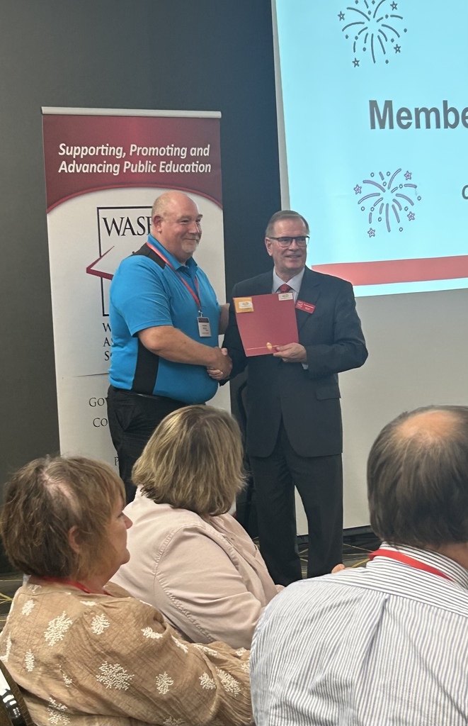 Kevin Blake receiving an award from Dan Rossmiller.