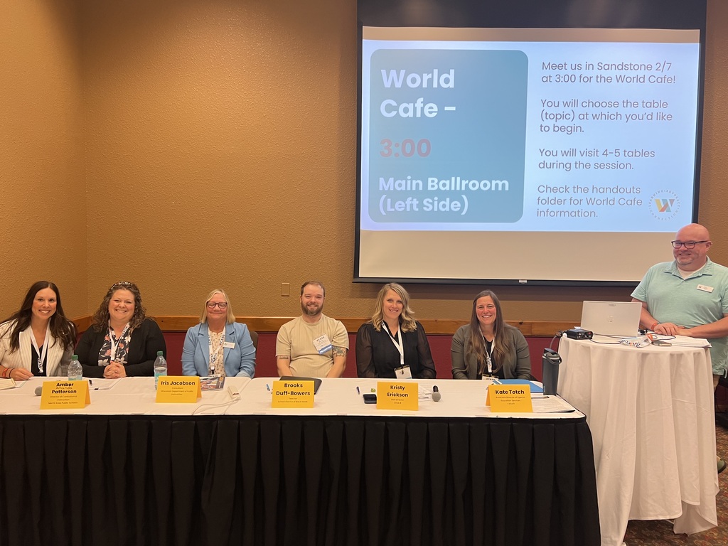 Panel discussion in front of a screen with a presentation
