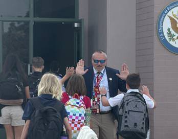 Dr. Davis greeting students as they enter the Mesa Academy for Advanced Studies