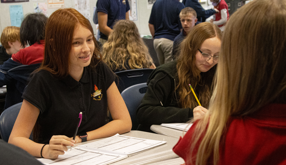 Female student surrounded by peers.
