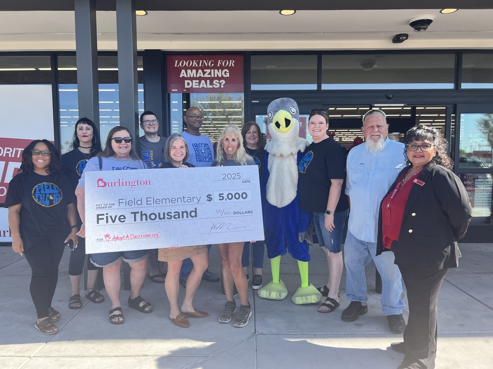 Picture holding large check with a falcon