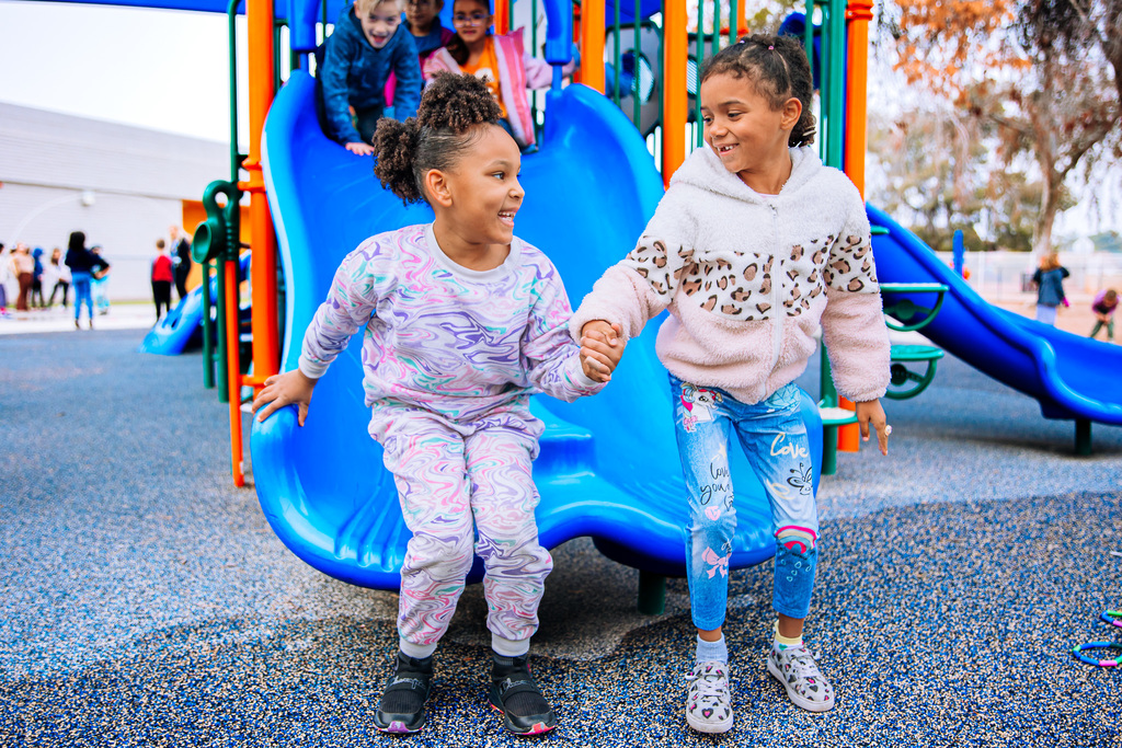 Children Hold Hands on Playground