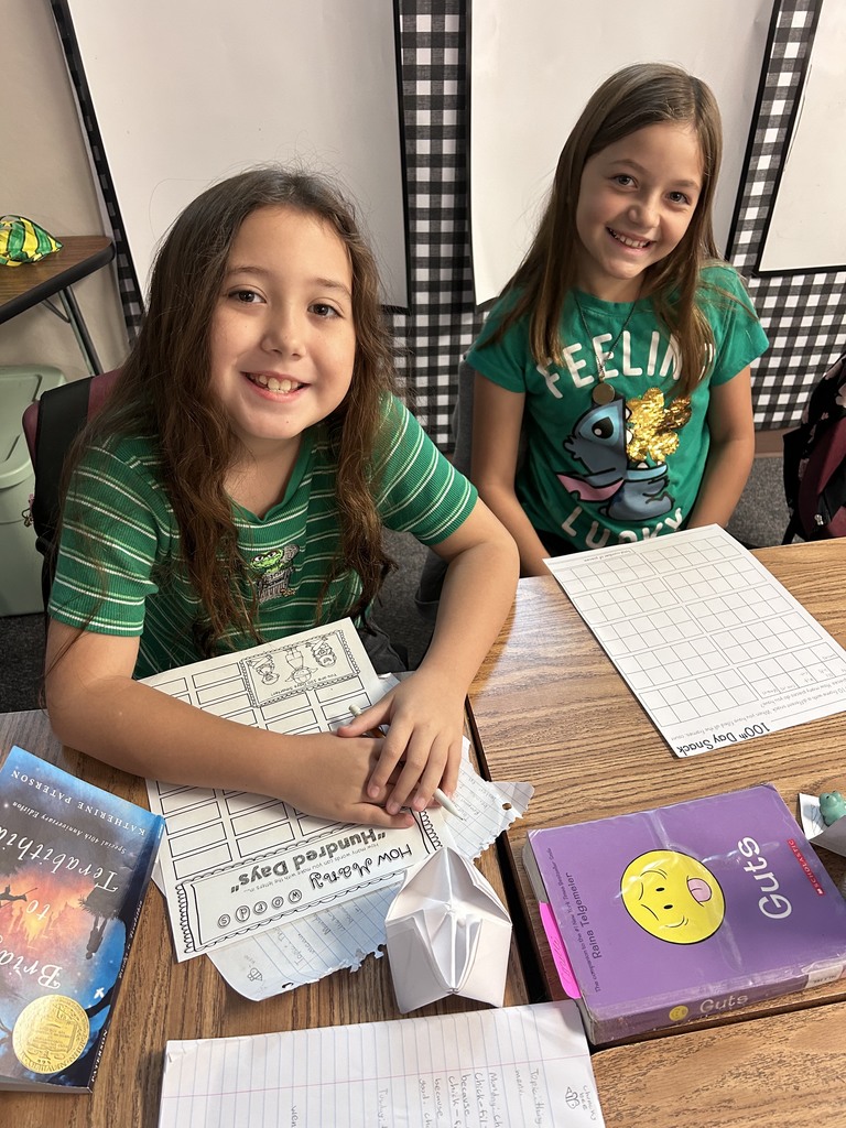 two girls happy doing school work 