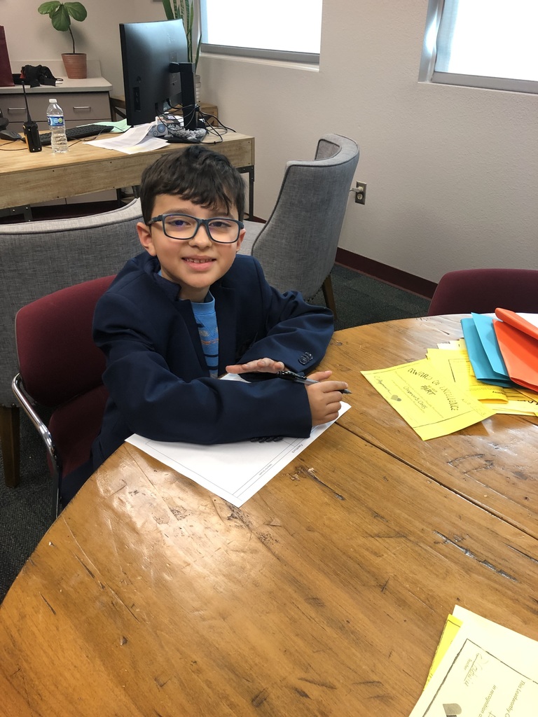 young boy working at a table