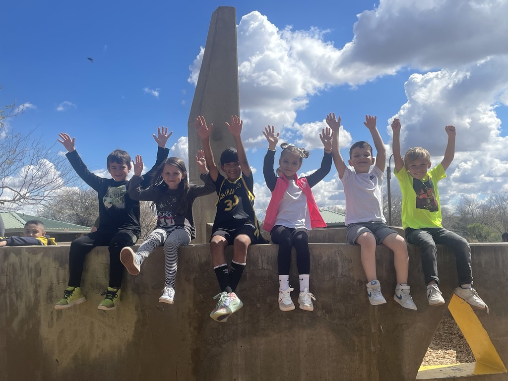 children sitting on wall