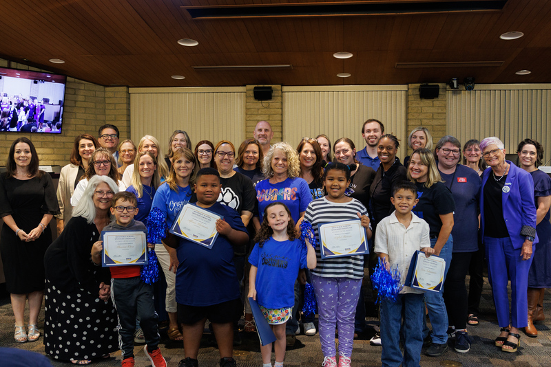 A group picture of students, staff and administrators from Crismon Elementary in the Governing Board Room.