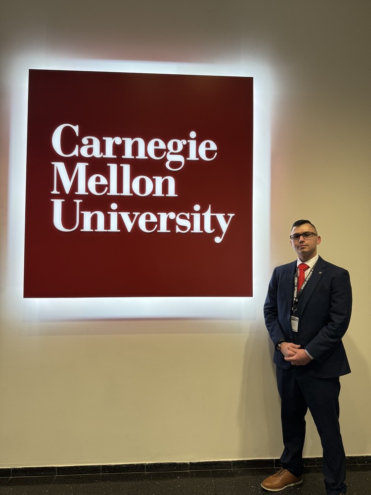 Raymond next to Carnegie Mellon University sign