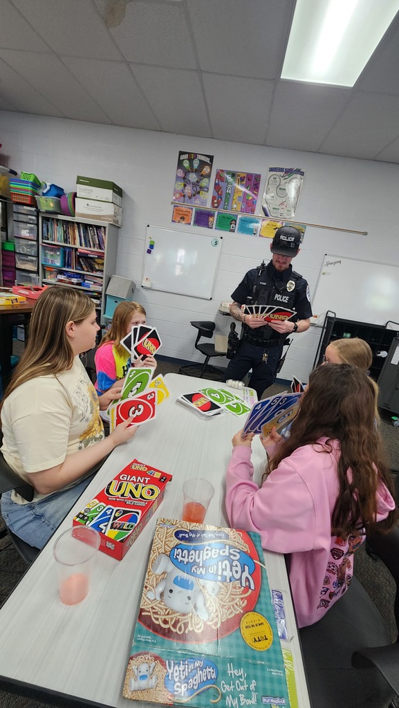 Officer Stone stopped by the cafe to join a game of UNO.