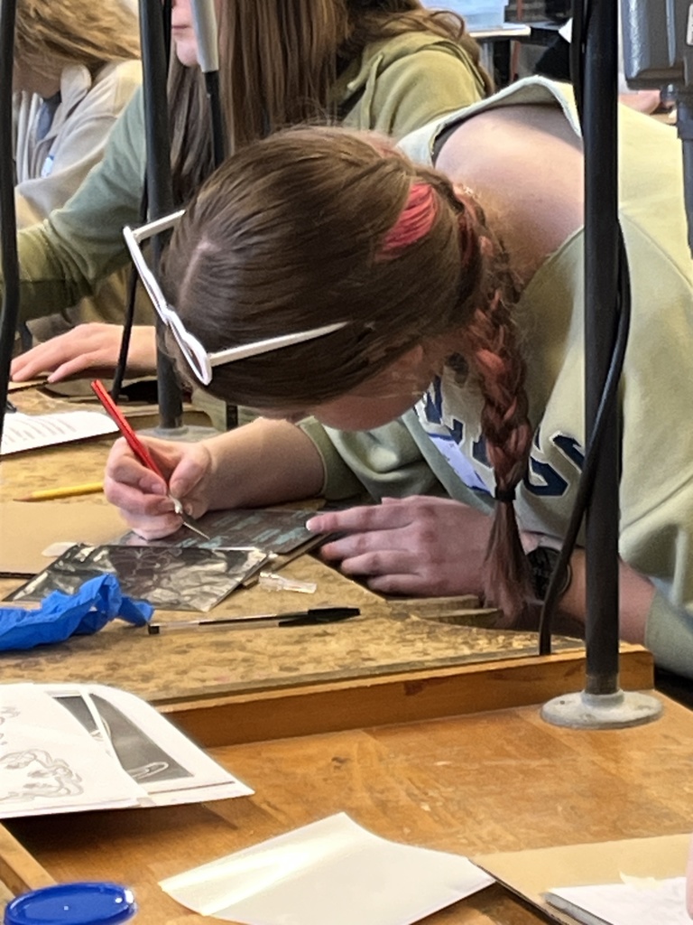 Ce Ce cutting her design for her glass etching
