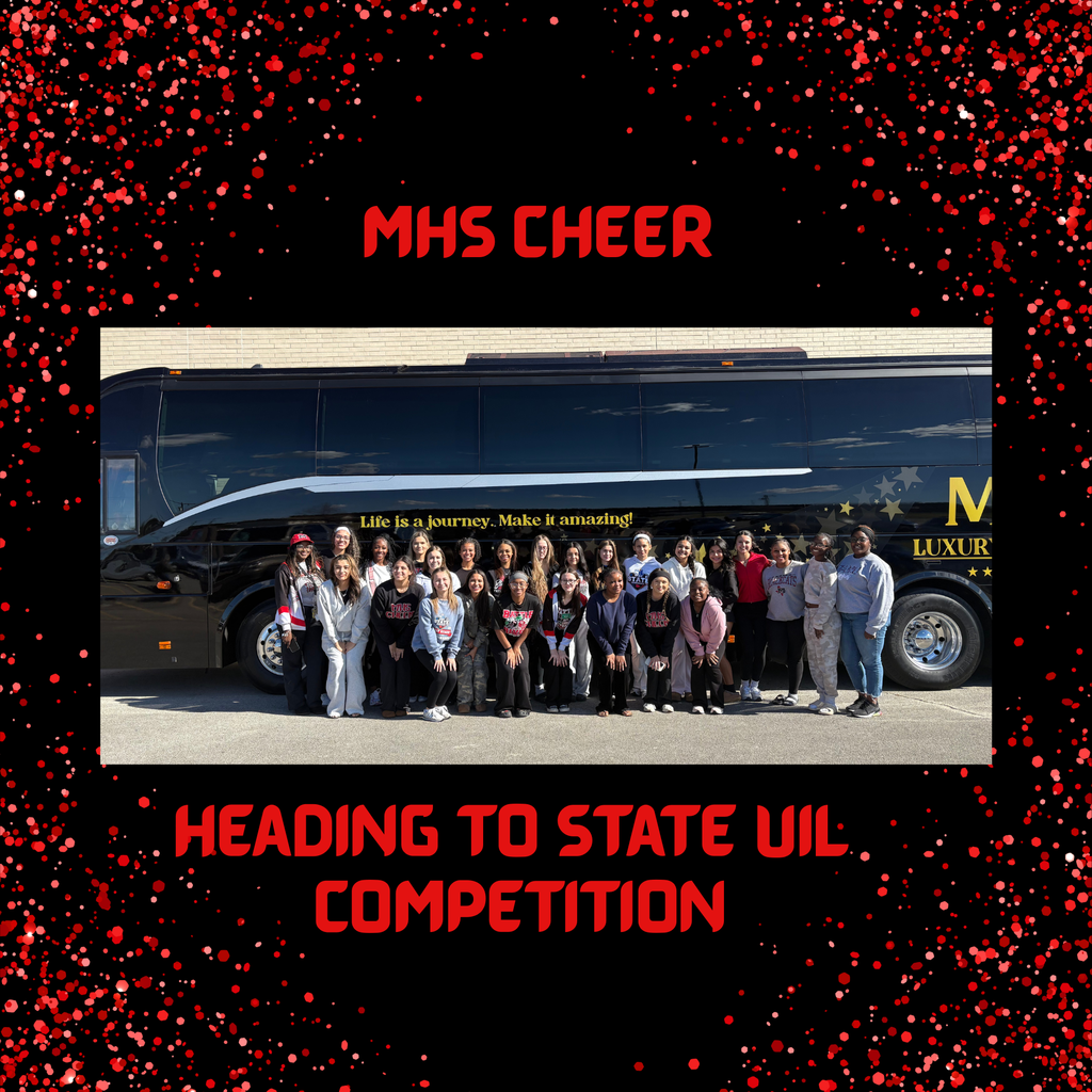 cheerleaders standing in front of charter bus