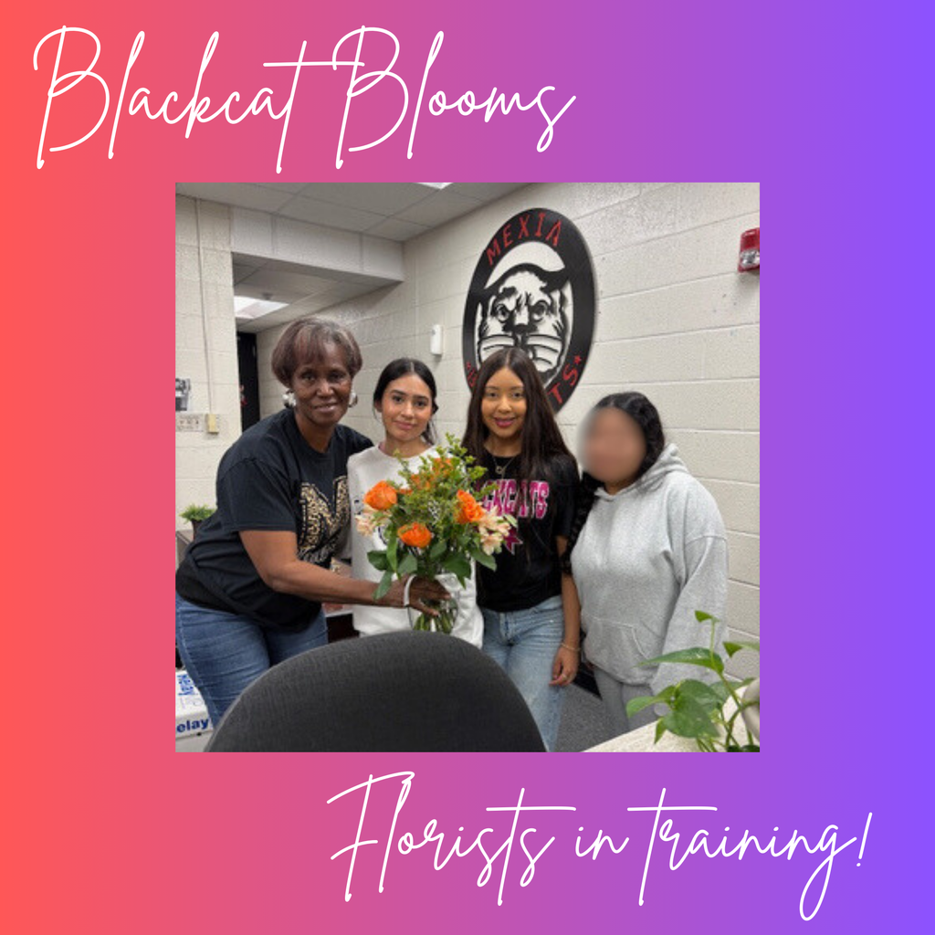 3 ladies presenting Ms. Hubbard with floral arrangement