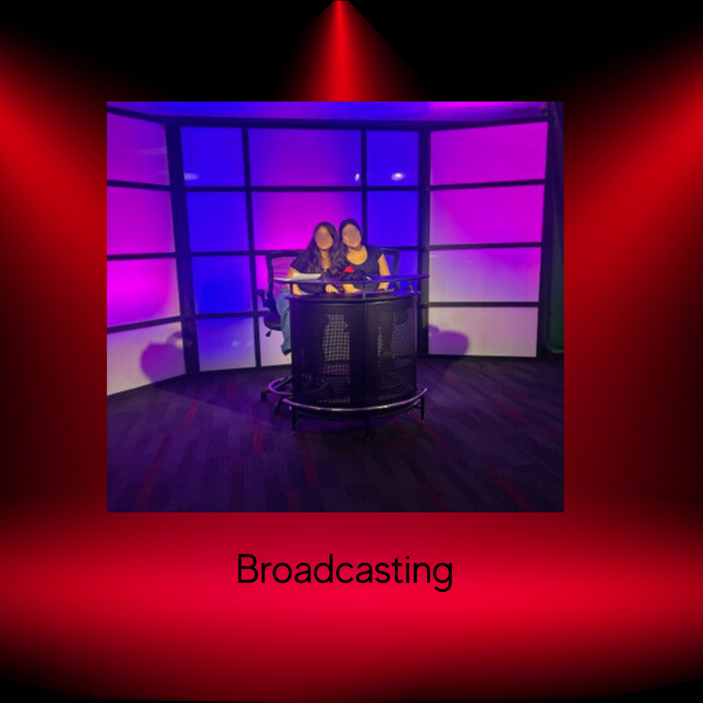 2 students posing in the broadcasting booth