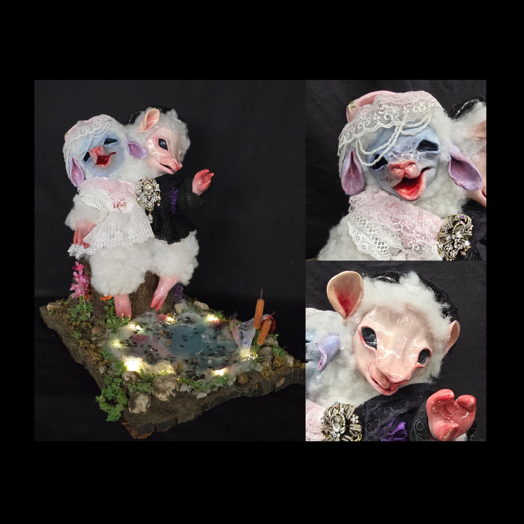 two headed Lamb statue standing in front of a lit up pond