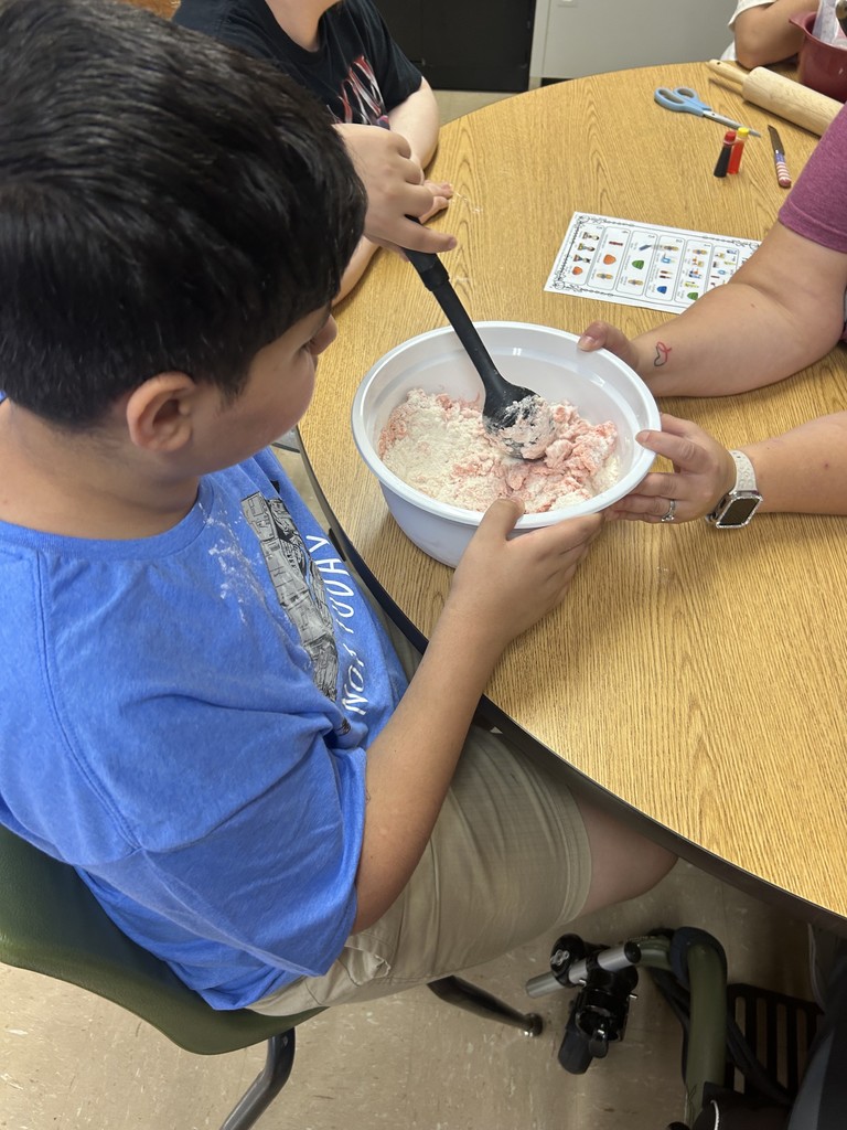 Ms. Hinkle’s class made playdoh during cooking. We used measuring cups to measure flour, oil, and water. We mixed red and yellow food coloring to make it orange like a pumpkin.