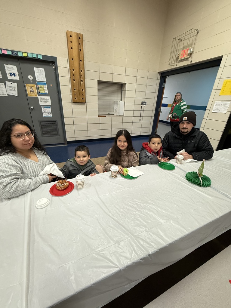 Family eating donuts at Santa Breakfast