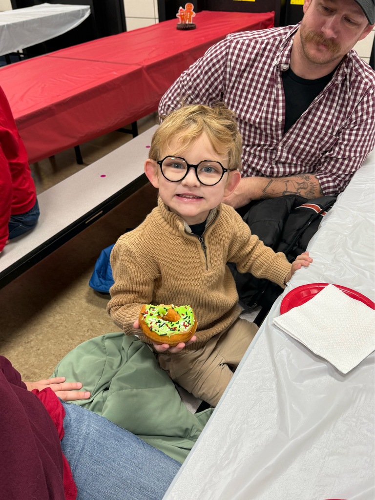 Student eating donut at Bauer Breakfast with Santa