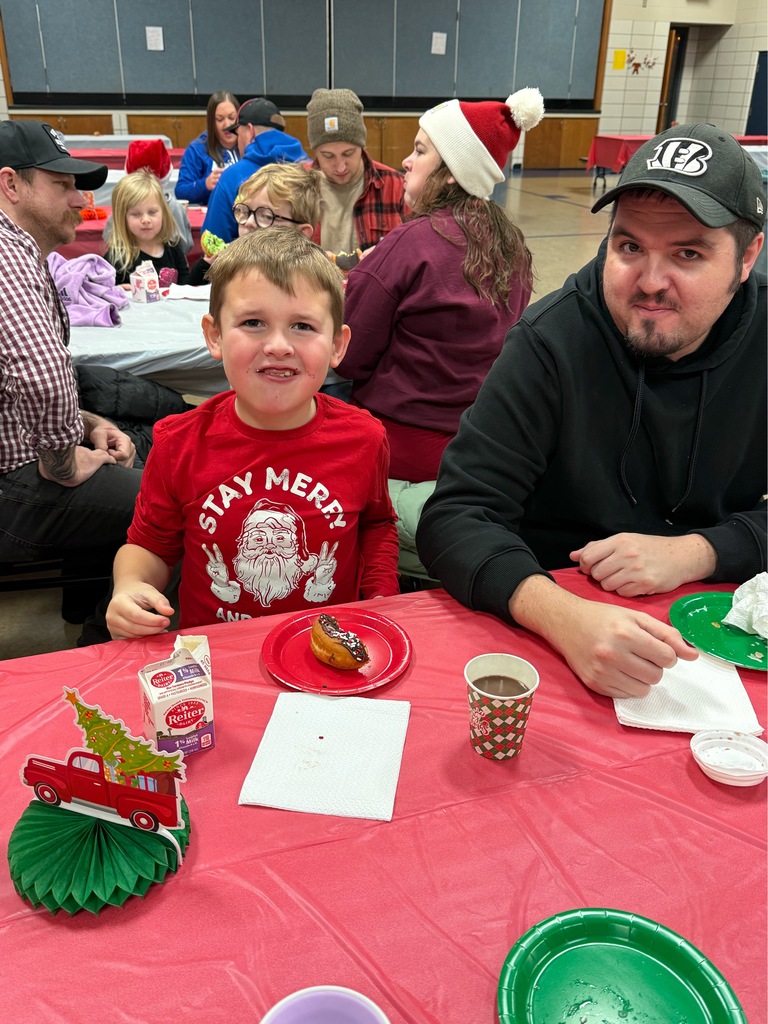 Student eating donut at Bauer Breakfast with Santa