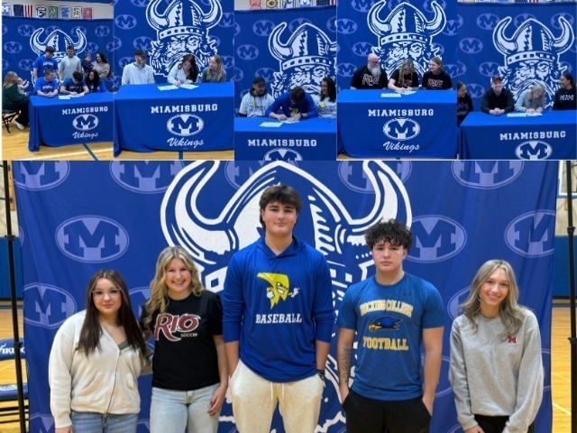 Four individuals stand together in front of a blue backdrop with a large M. Two men wear blue shirts, and two women wear white shirts.