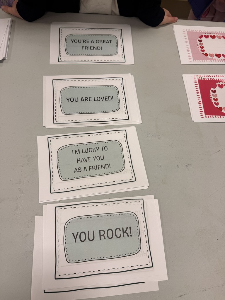 Several cards with positive messages on a table. Cards include "You're a great friend!" and "You are loved!"