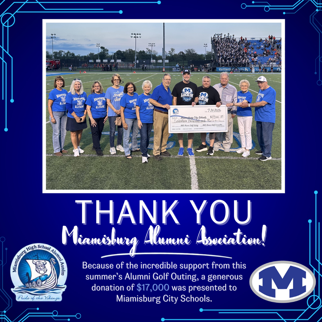Eleven people in blue shirts and caps stand on a football field with a large check.