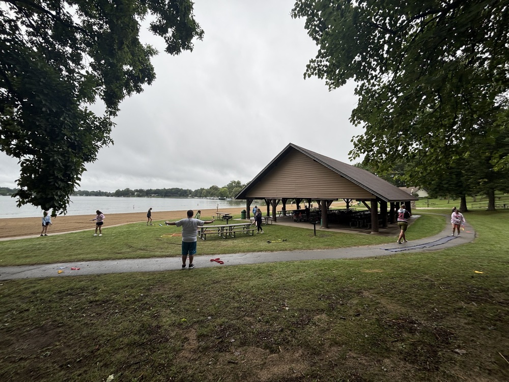 students working out near a pavilion on the beach