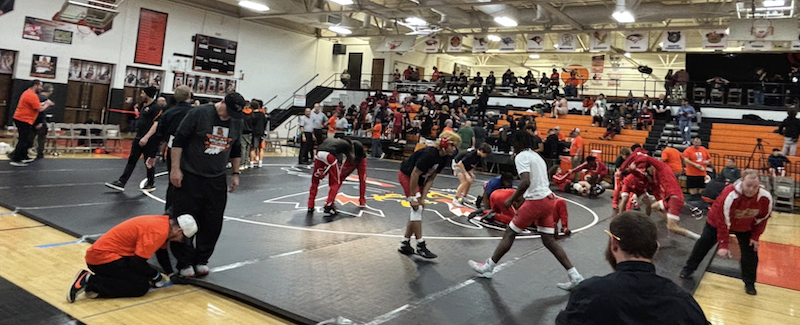 Wrestlers stretching before the tournament